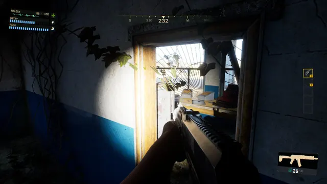 The player searches a dark, abandoned building with a rifle