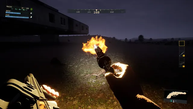 A muzzle flash lights up the night near an abandoned building